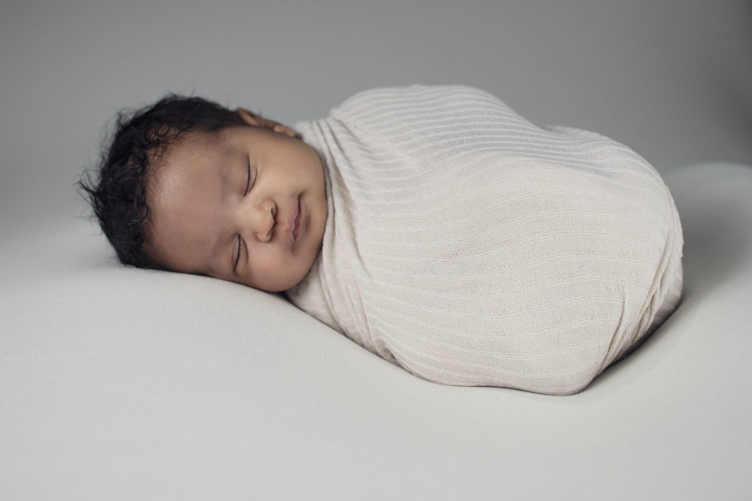 Baby wrapped in blanket comfortably